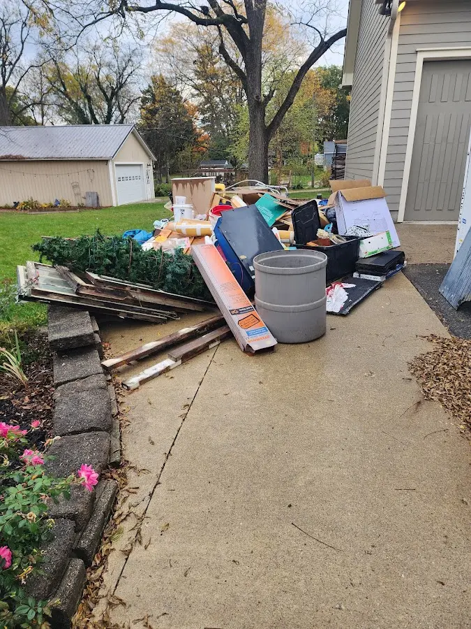 Dumpster being loaded with debris for Estate Cleanout Dumpster Rental in Jay